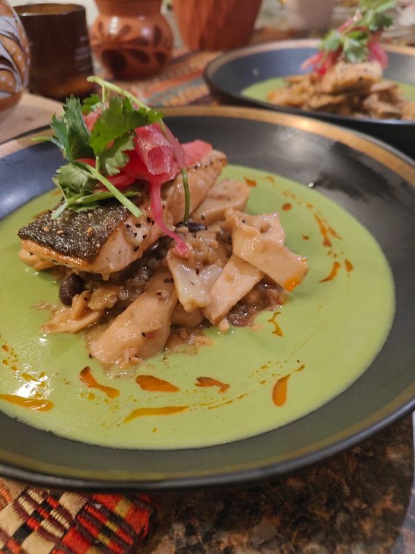 Crispy-skin salmon over green mole plated by Chef Brian Schultze, private chef.