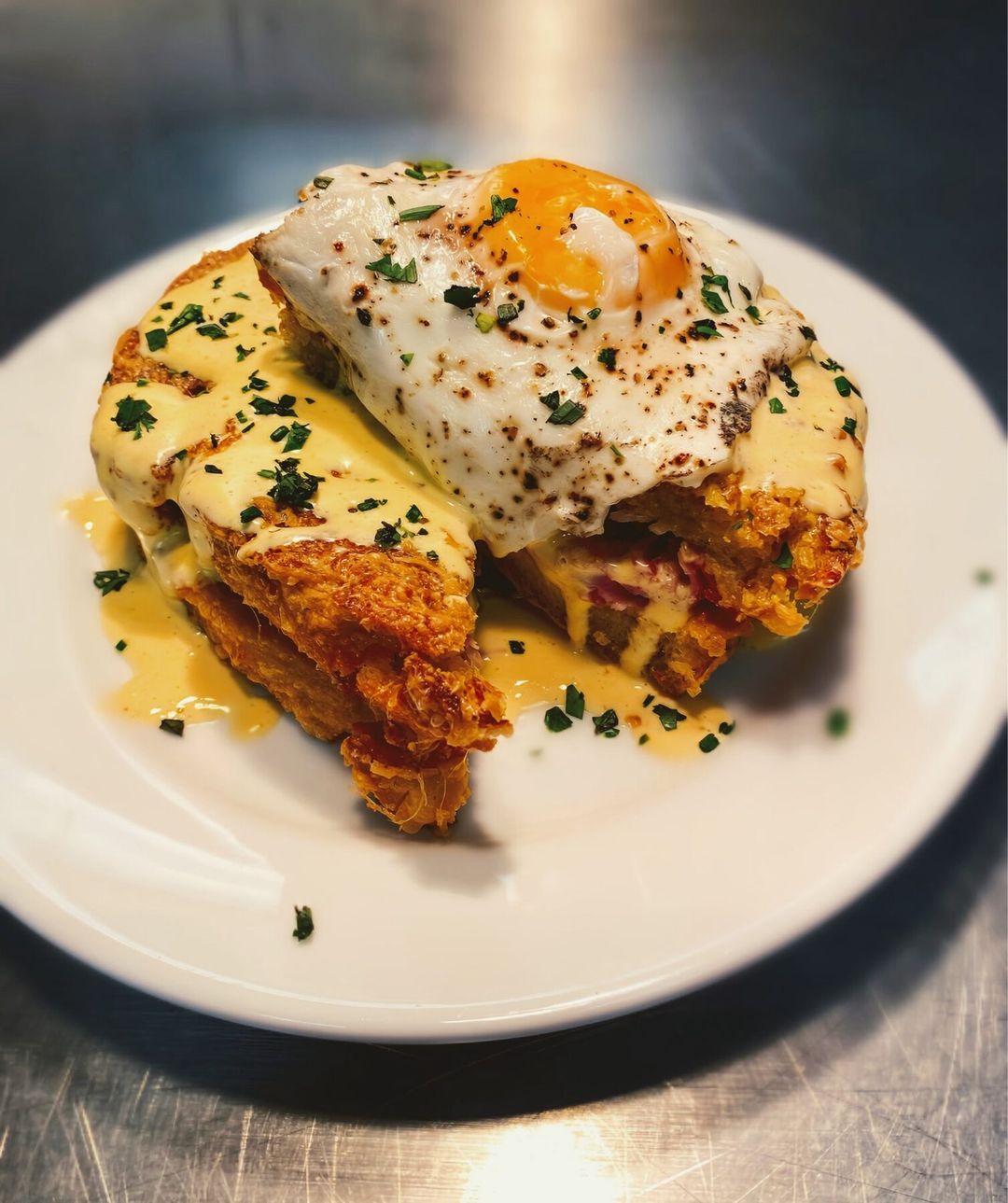 Croque madame with a fried egg plated by Chef Brian Schultze, private chef.